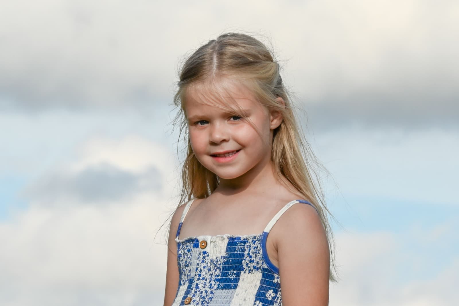 A photo of a girl smiling outdoors